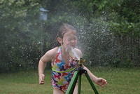 Playing in sprinkler - June 2, 2013